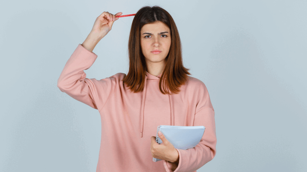 Girl holding pen with copy and thinking about something